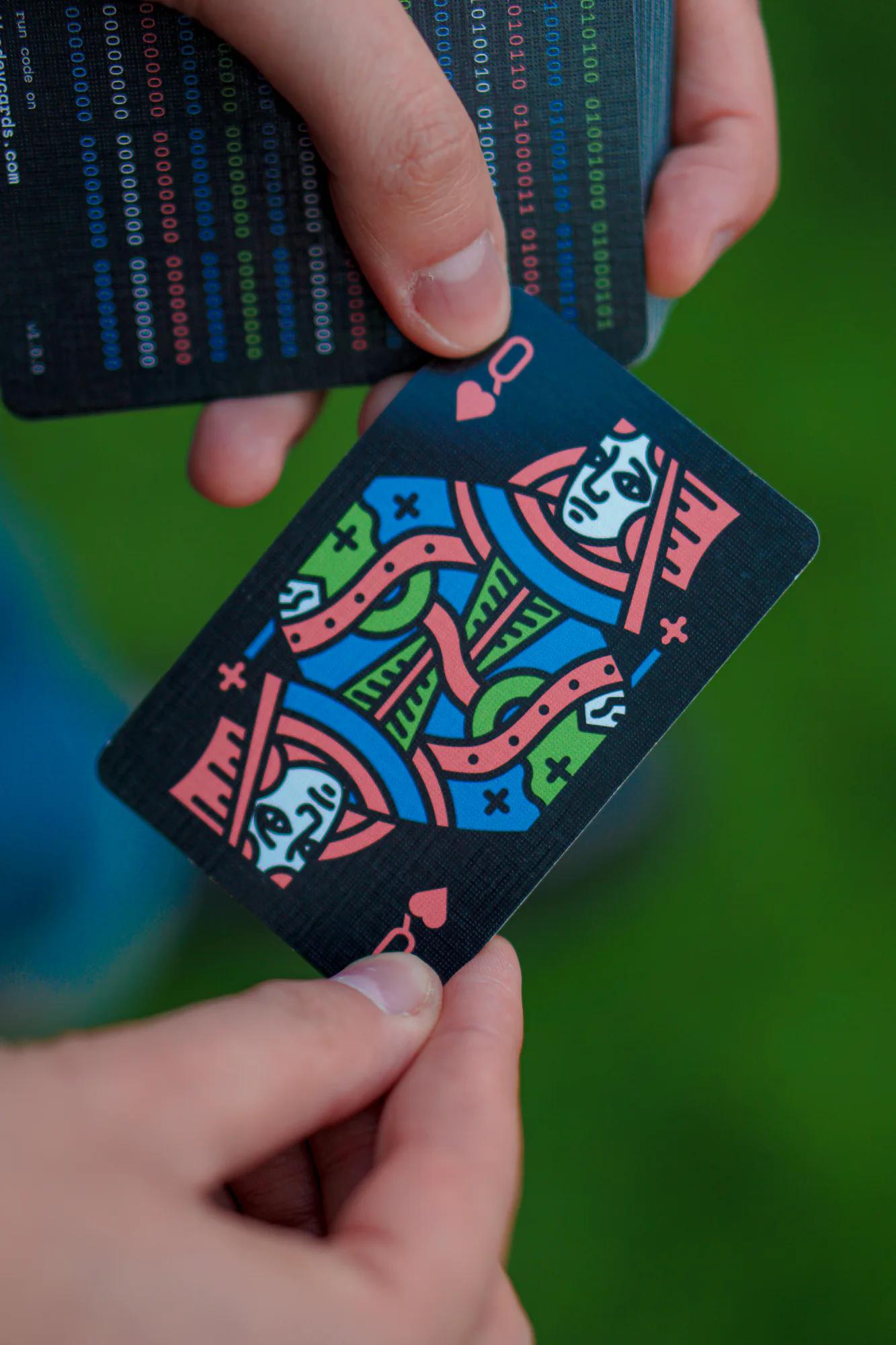 A developer holding a colourful TheDevCards playing card